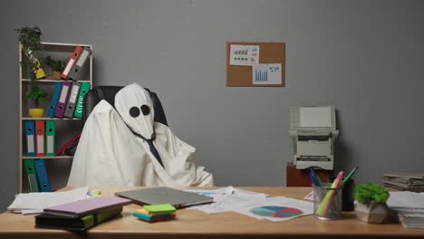 a ghost sitting at a desk in an office