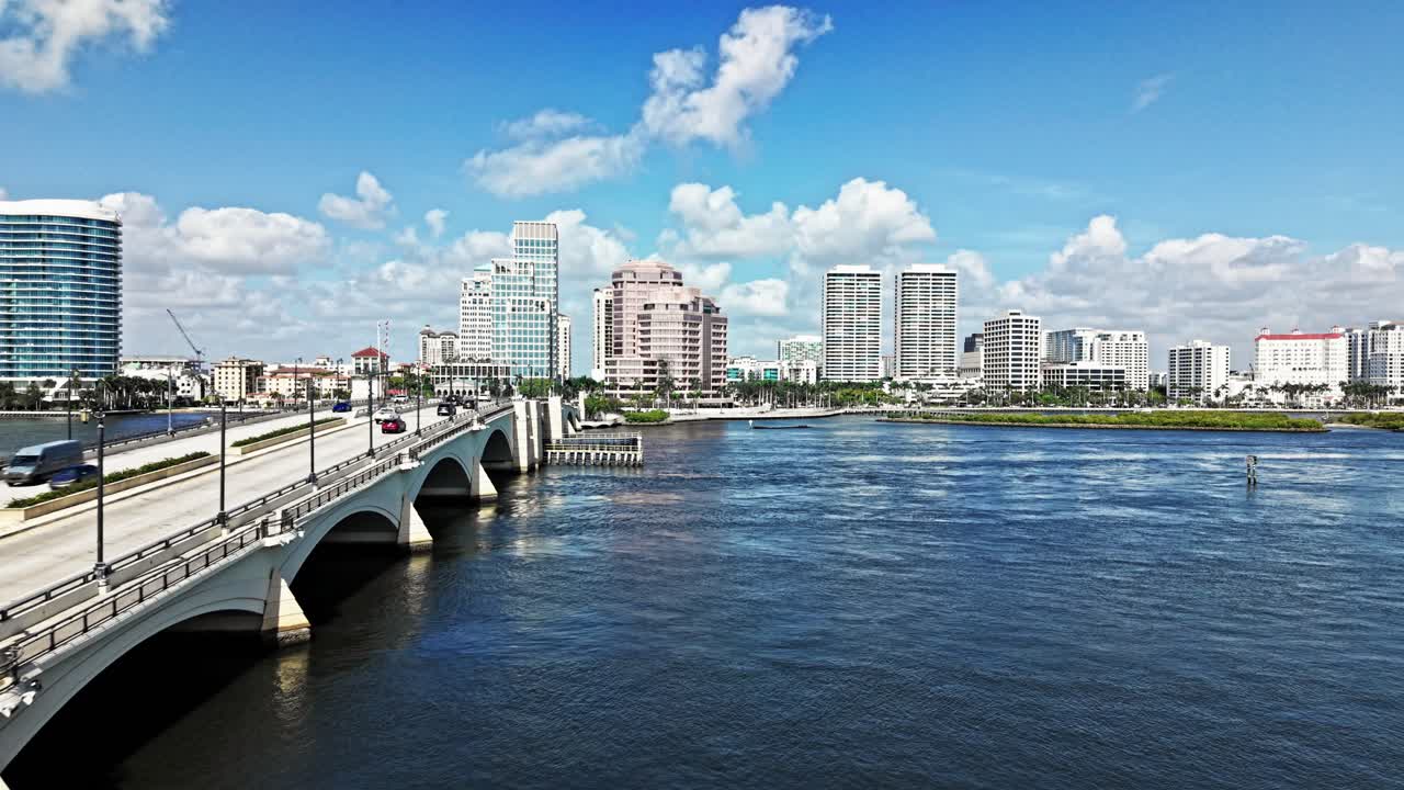 Dolly in drone shot of cityscape with Royal Park Bridge, One Flagler and Phillips Point building during the day in West Palm Beach, Florida, USA