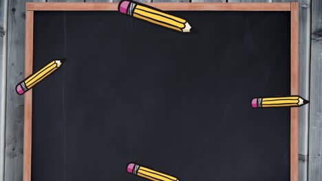 animation of pencils falling over black board with copy space