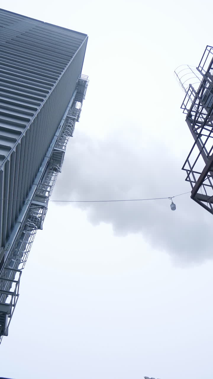 Huge modern elevator production. Big factory exterior construction. Vertical video