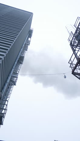 huge modern elevator production. big factory exterior construction. vertical video