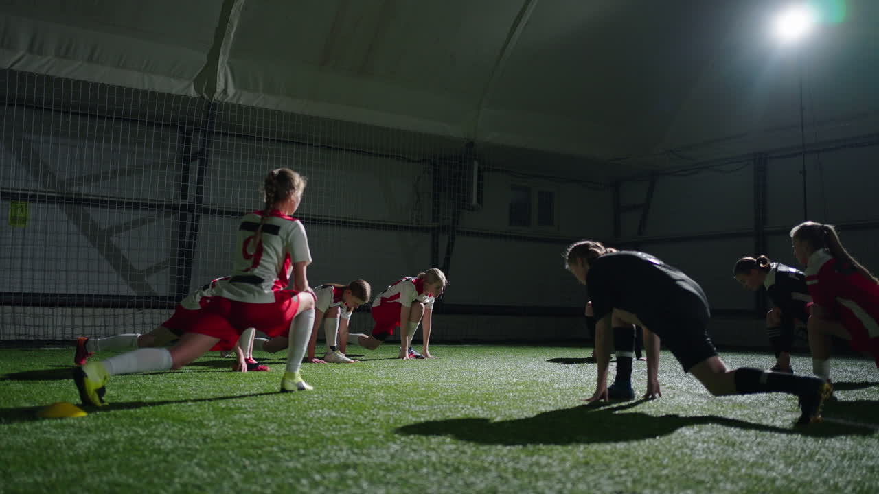 여자 축구 팀 이 경기 전 에 스트레칭 을 하고 있다