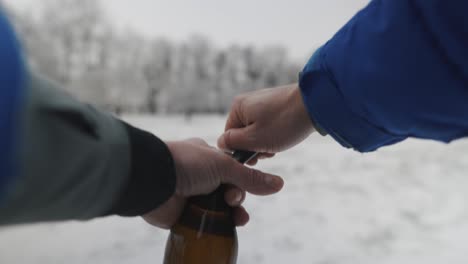 pov man opening up a bottle of german beer with a lighter