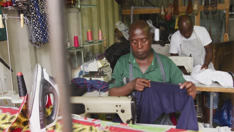 african men sewing together