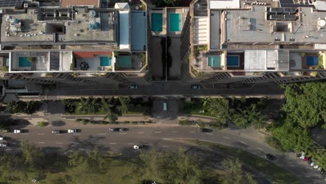 Slowly-backing-aerial-view-of-residential-high-rise-condominiums-residing-in-the-partly-cut-out-mountain-side-revealing-the-entire-mountain-behind