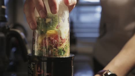 blending the mixed smoothie ingredients with a blender - close up shot