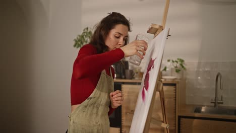 woman painting in a home studio