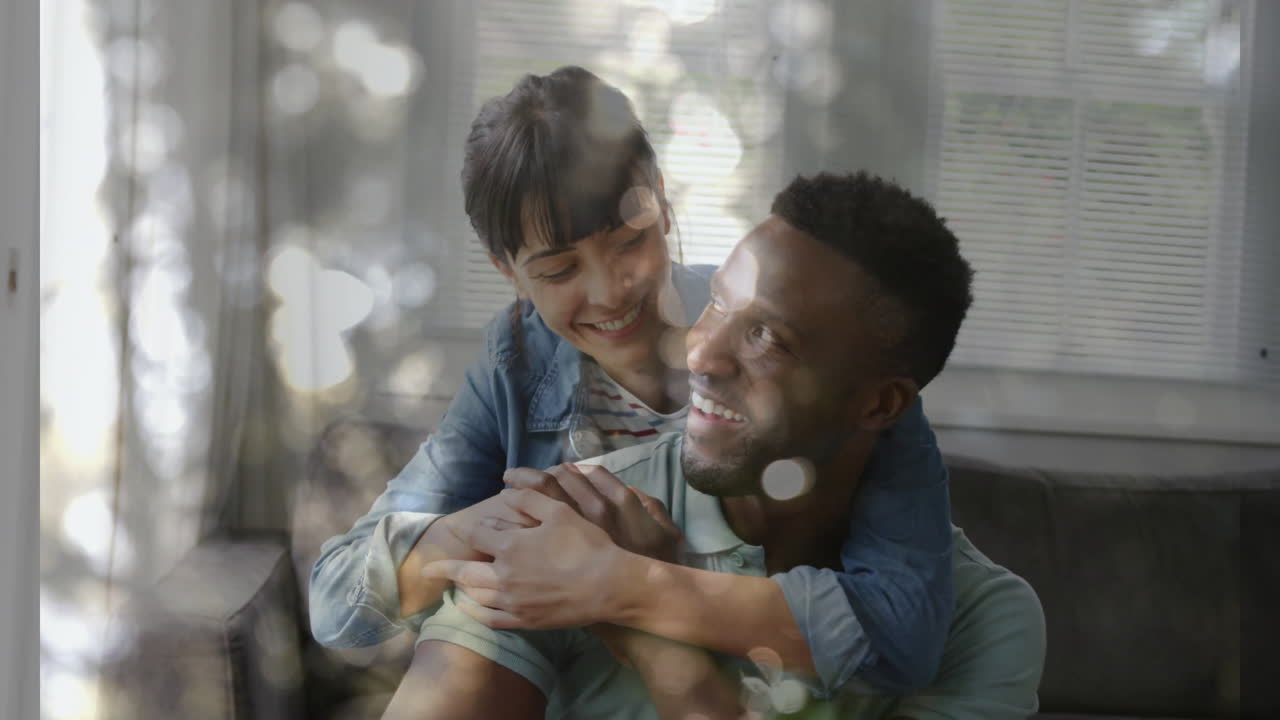Embracing couple with light reflections, creating animation effect at home