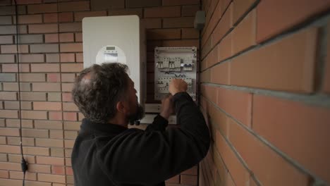 an electrician installing an inverter in a home. the image shows technical skill, modern tools, and attention to safety in electrical work