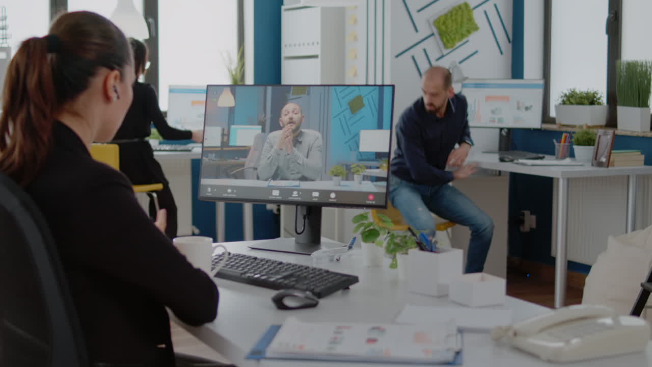 Businesswoman using video call on computer for meeting with boss