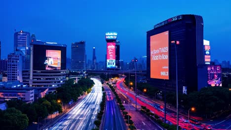 cityscape at night with traffic and light trails