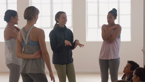 healthy group of women in yoga class enjoying conversation sharing lifestyle discussing fitness practice chatting in studio