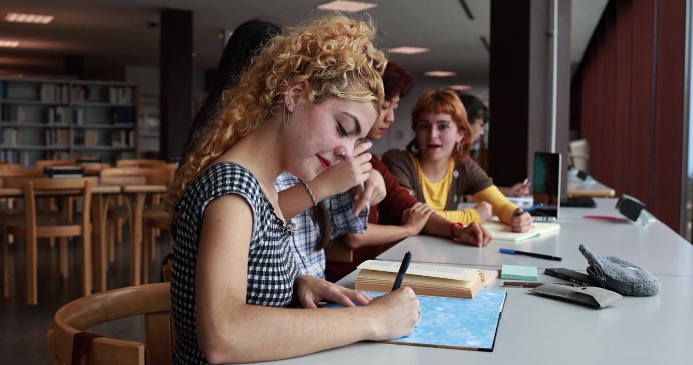 Group of Young Students Studying Together in a Library