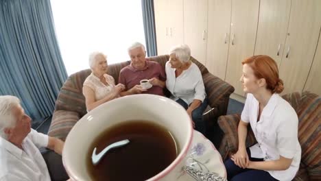 Smiling-doctor-and-patient-talking-while-having-tea