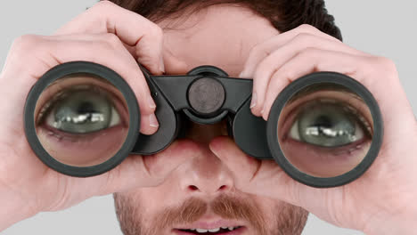 man looking through binoculars