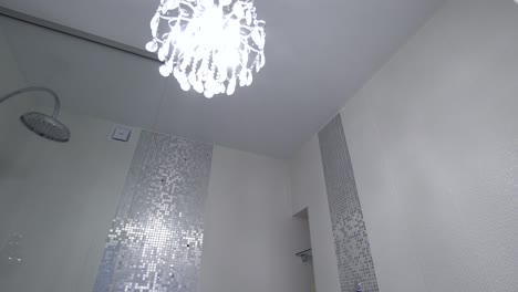 modern white bathroom with silver mosaic tiles