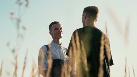 Men-holding-hands-outdoors