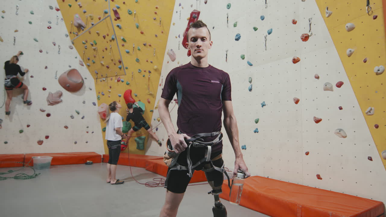 Portrait Of Sportsman With Leg Prosthesis At Wall Climbing Complex