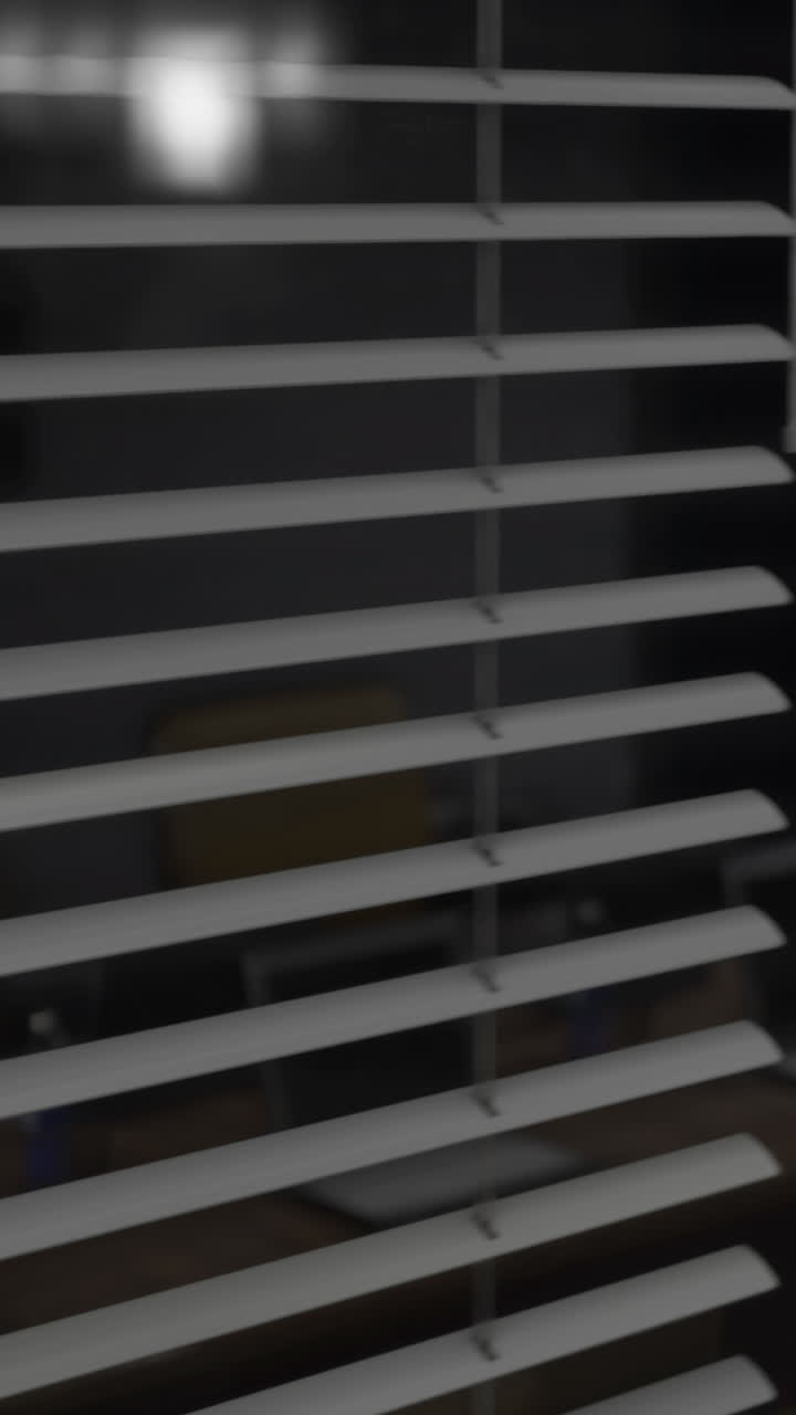 Shadows dance through blinds during a quiet evening in a cozy study