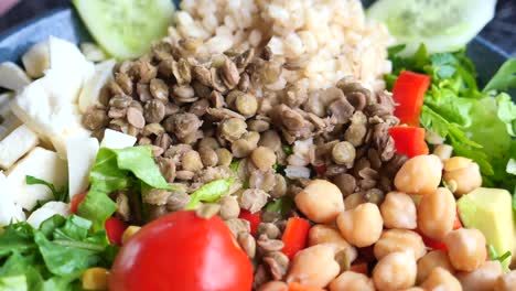 close up of a healthy and delicious salad with lentils, chickpeas, rice, and vegetables