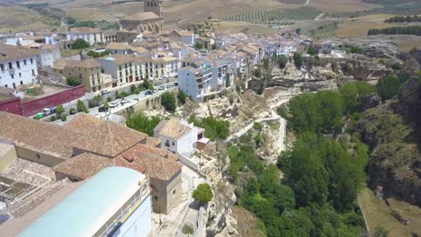 aerial ascending shot of the canyon of alhama de granada and its old church in the middle of the town