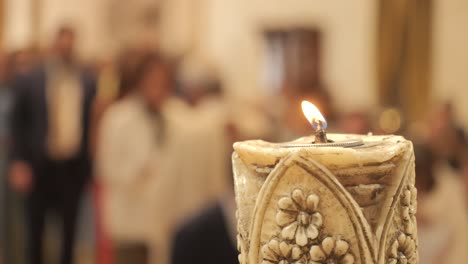 single decorative candle light in church in ceremony