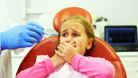 paciente joven asustado durante un chequeo dental