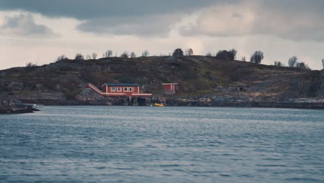 fishing cabin and small pier on the rocky seashore