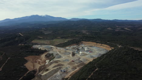 aerial view of a quarry and mining operations in a mountainous landscape