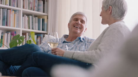 happy-old-couple-drinking-wine-relaxing-on-sofa-at-home-making-toast-celebrating-anniversary-enjoying-romantic-relationship-on-comfortable-retirement-4k-footage