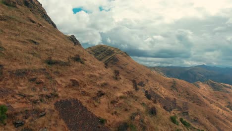 Golden-peaks-in-the-Peruvian-Andes-near-Cusco,-Huancaure-trek,-dolly-in-aerial