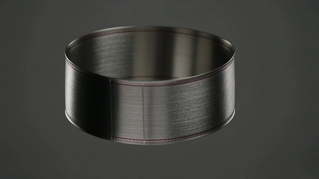 Rotating dark metallic band tilting to reveal cavity at studio backdrop, highlighting seam