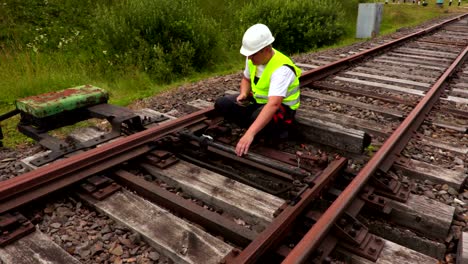 worker using tablet pc on railway track