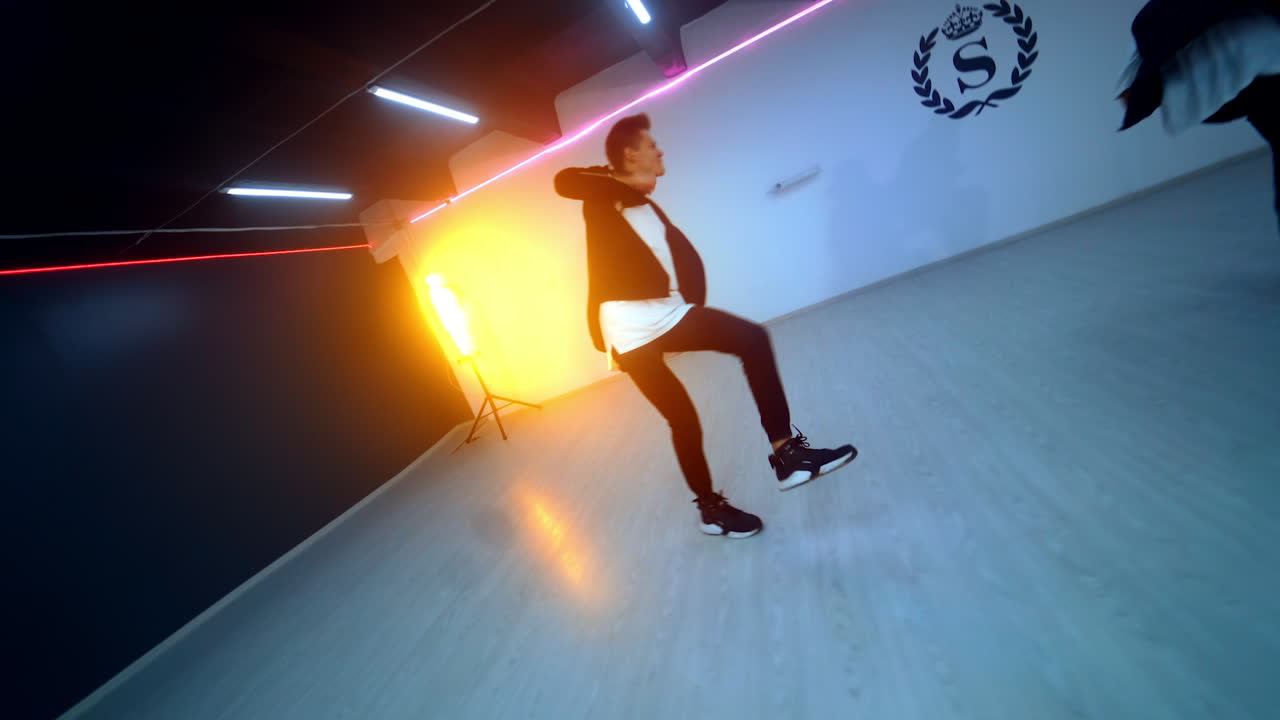 Cheerful young boys performing hip hop in the spacious studio. Dance club trio practicing.