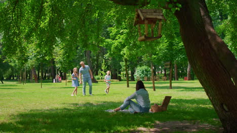 cheerful family leisure in summer park. active games together on fresh air.