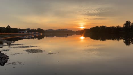 beautiful sunrise over the river, view from the embankment (4k60)