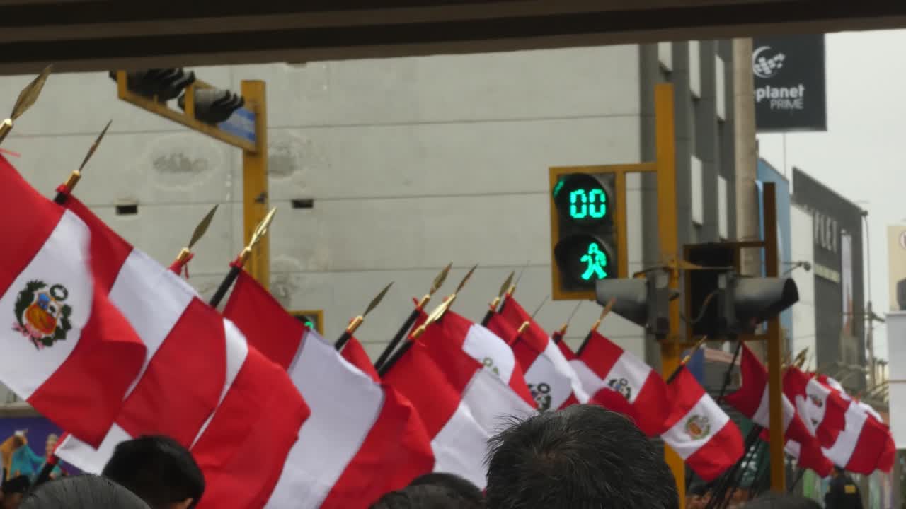A line of Peruvian flags blowing in the wind in the middle of a street intersection in Lima, Peru.