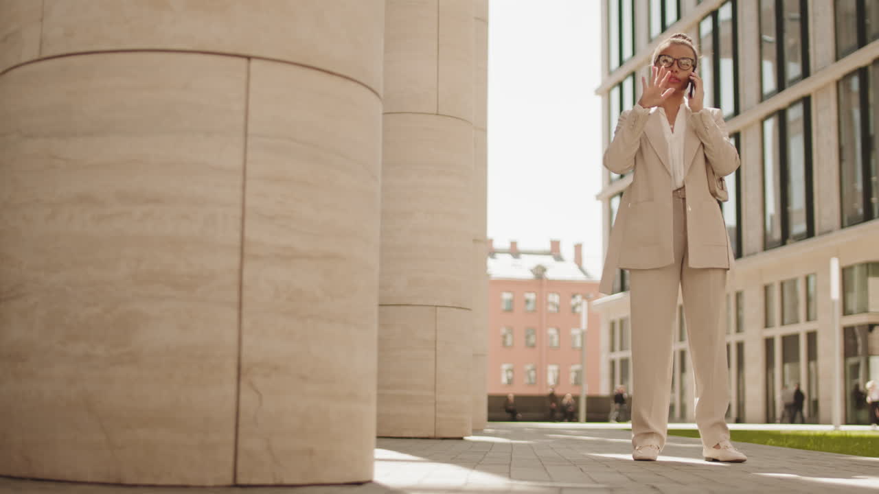 Stylish Businesswoman Making Phone Call Outdoors
