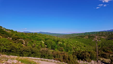 Landscape-pan-of-scenic-countryside-rural-land-bushland-forest-in-suburban-town-neighbourhood-with-mountain-range-Athens-Greece-Europe-travel-holidays-vacation