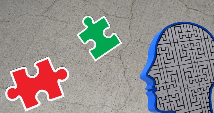 Animation of green, yellow and red puzzle pieces falling over model of human head on grey background