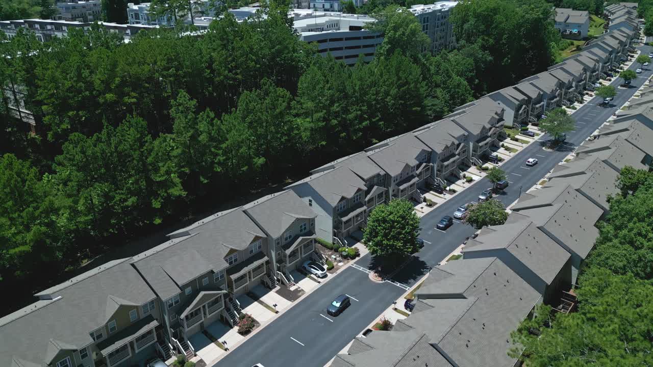 Modern row of multifamily townhouses, in modern architectural design with distinct rooflines and facades. Row or detached houses in suburb, Atlanta. Aerial view