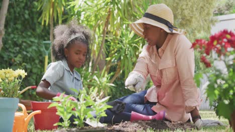 mother and daughter gardening during a sunny day