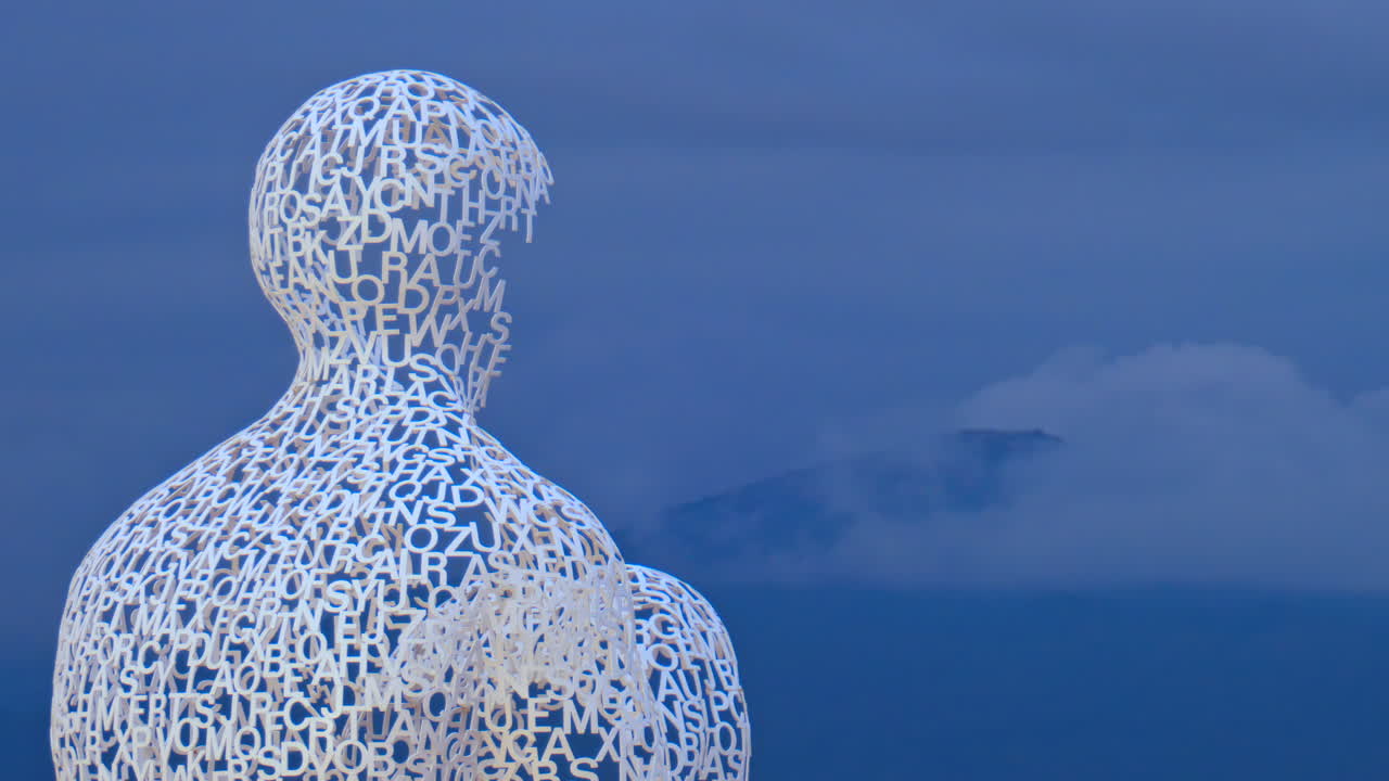Distant view of The Nomad urban sculpture by Jaume Plensa in the evening in Antibes, France