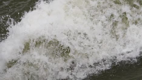 Foam-water-flows-spraying-and-splashing-due-to-a-high-speed-motorboat-on-the-lake