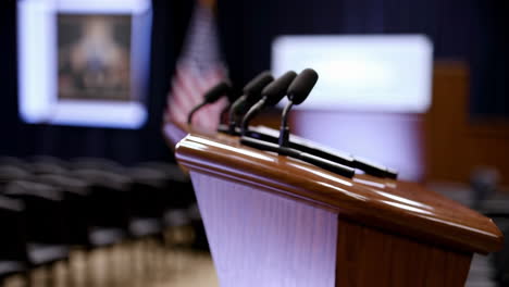 empty press briefing room with podium and american flag