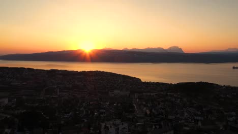 aerial view of sunset over city by the ocean