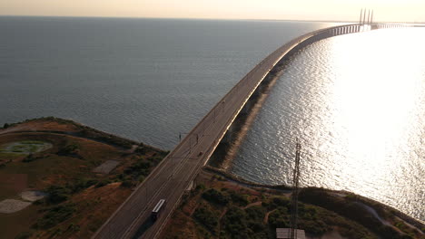 4K-Inspire-2-drone-footage-of-cars-driving-onto-the-Öresundsbro-in-Southern-Sweden-during-a-summer-sunset