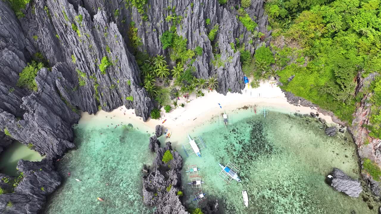 Tropical sandy beach surrounded by cliffs at El Nido, Palawan, Philippines. Travel destination
