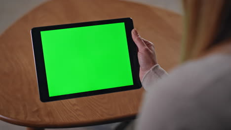 businesswoman hands browsing green screen tablet application at home close up.