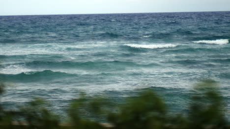 Water-big-waves-at-distance-,-rough-ocean-sea-isolated-lonely-beach